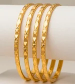 Gold-toned metal bangles featuring a faceted, geometric diamond-cut pattern (Set of 4)