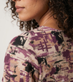 kurti featuring a round neckline with a small button placket and an abstract multi-tone print