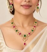 Gold Plated necklace set with alternating green and ruby-pink teardrop stones, white crystal accents, and matching drop earrings - Image 3